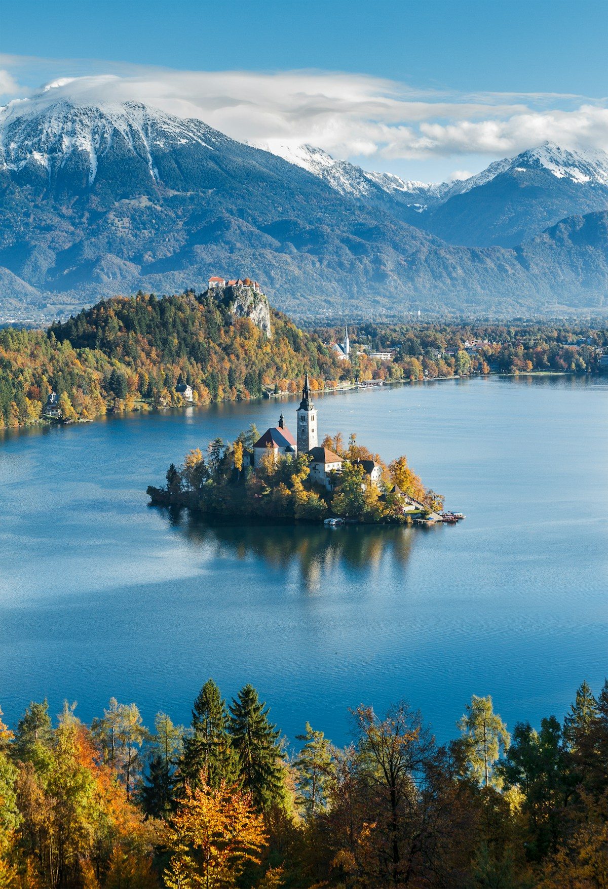 Lake Bled island surrounded by autumn trees